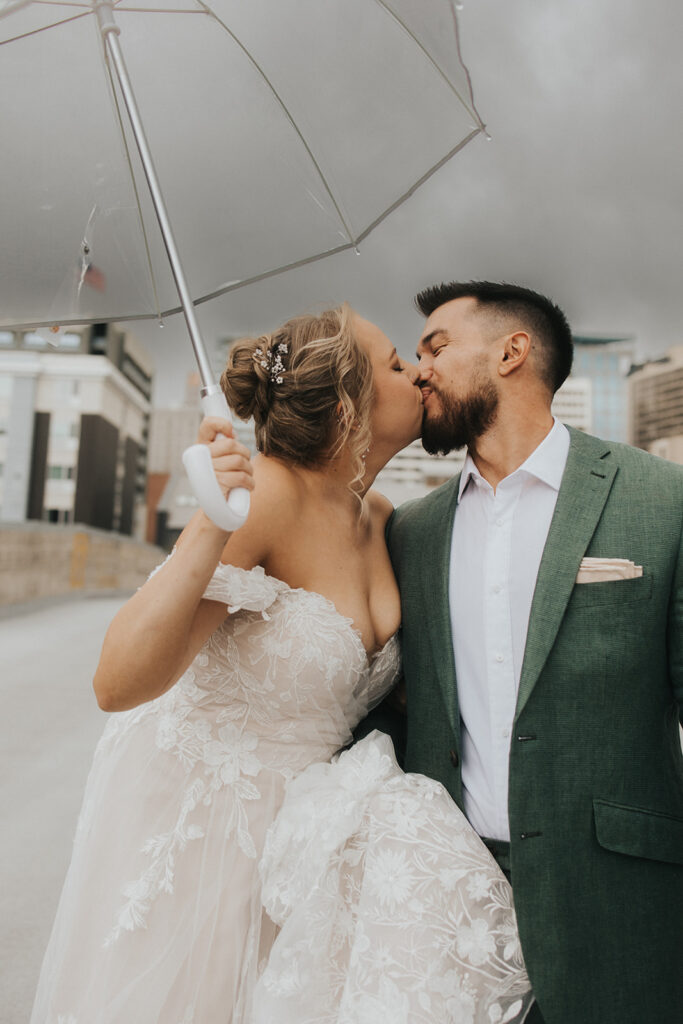 couple posing under an umbrella for their salt lake city wedding