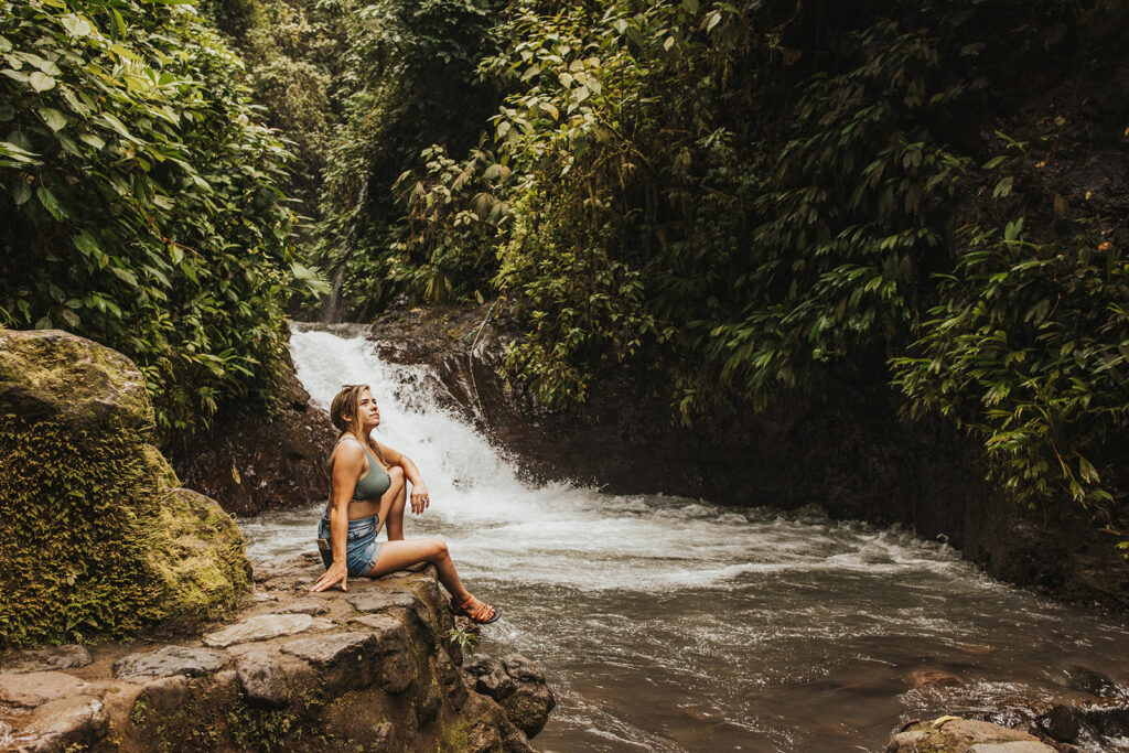 woman posing in costa rica by a waterfall