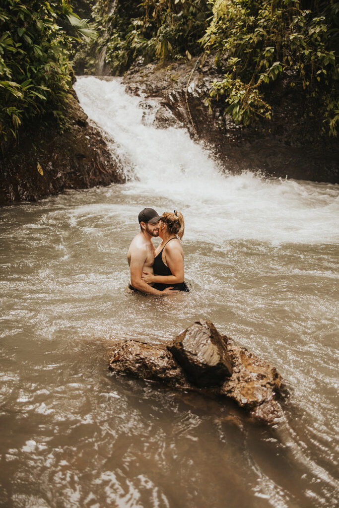 couple posing during their engagement session in the water