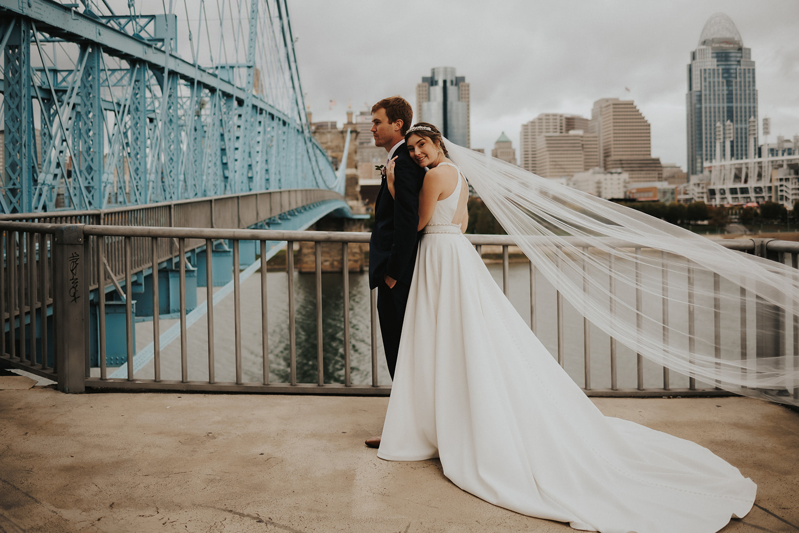 couple posing in front of a bridge for wedding photos