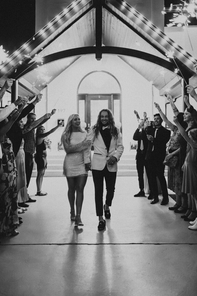 Black and white photo of the newly weds leaving their wedding
