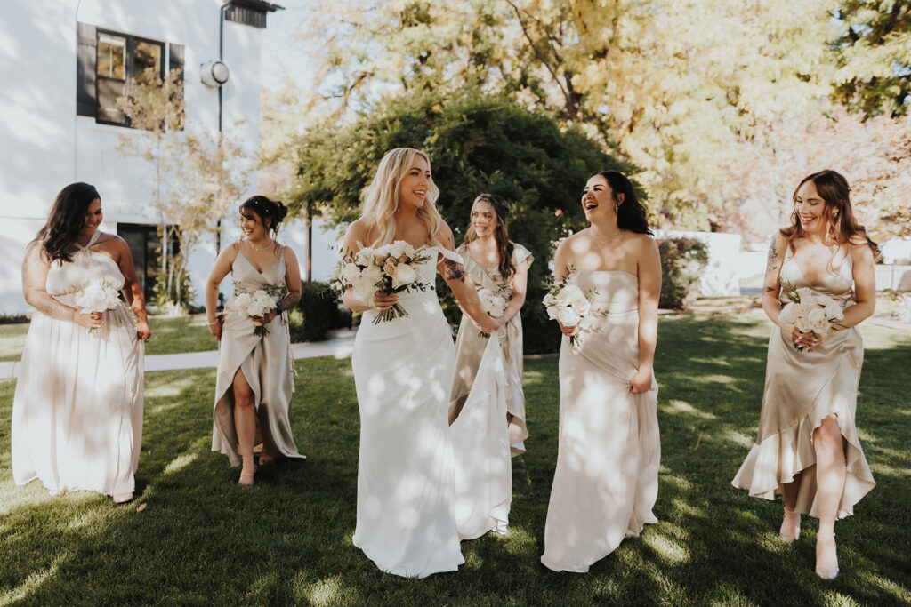 Bride and Bridesmaids smiling at each other before the ceremony at their intimate wedding