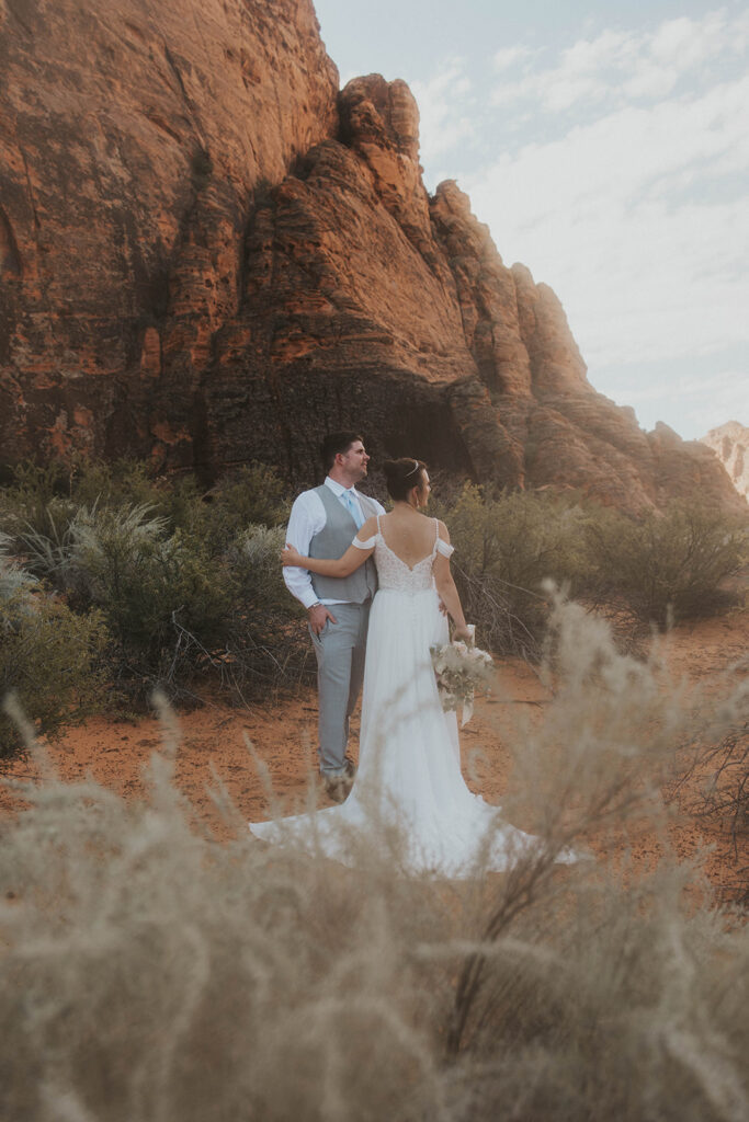 bride and groom hugging - how to elope in moab 