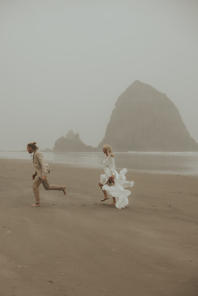 couple running around the beach