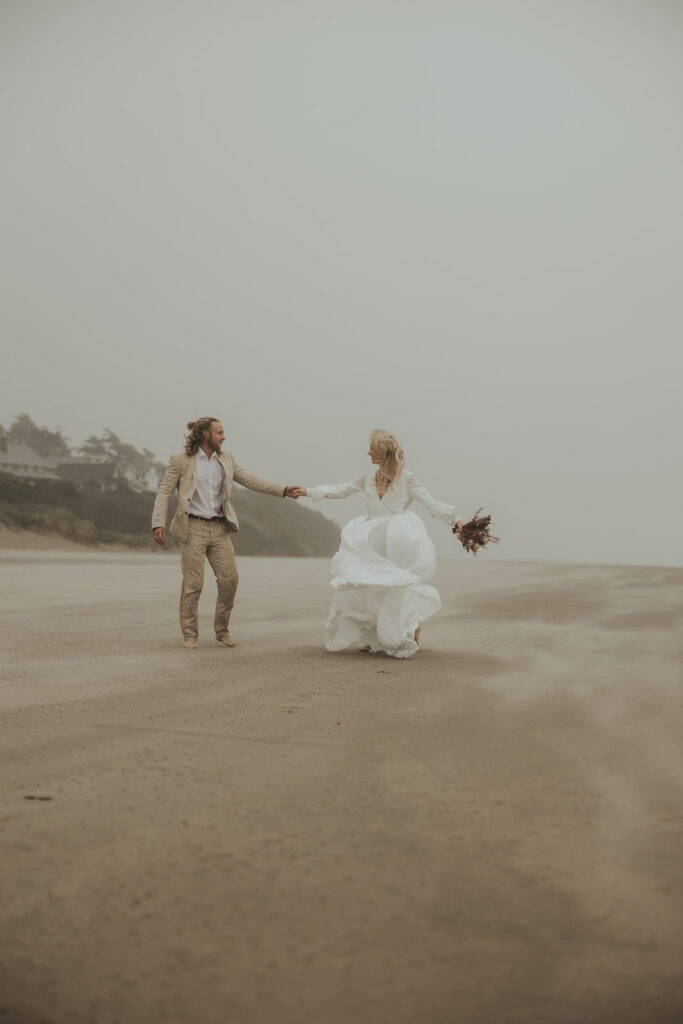 bride and groom dancing at the beach