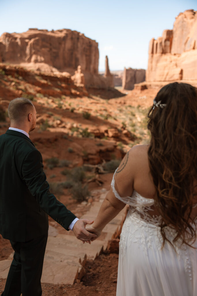 bride and groom holding hands