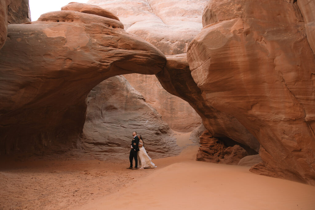 bride and groom at arches national park 