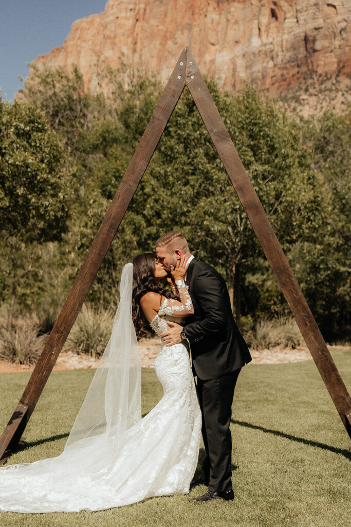 bride and groom kissing after their wedding ceremony 