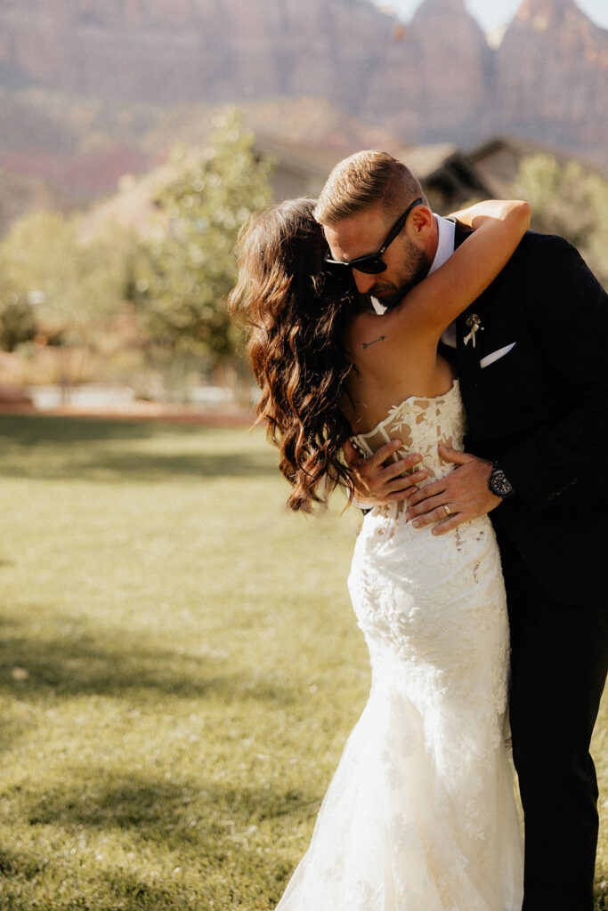 bride and groom hugging 