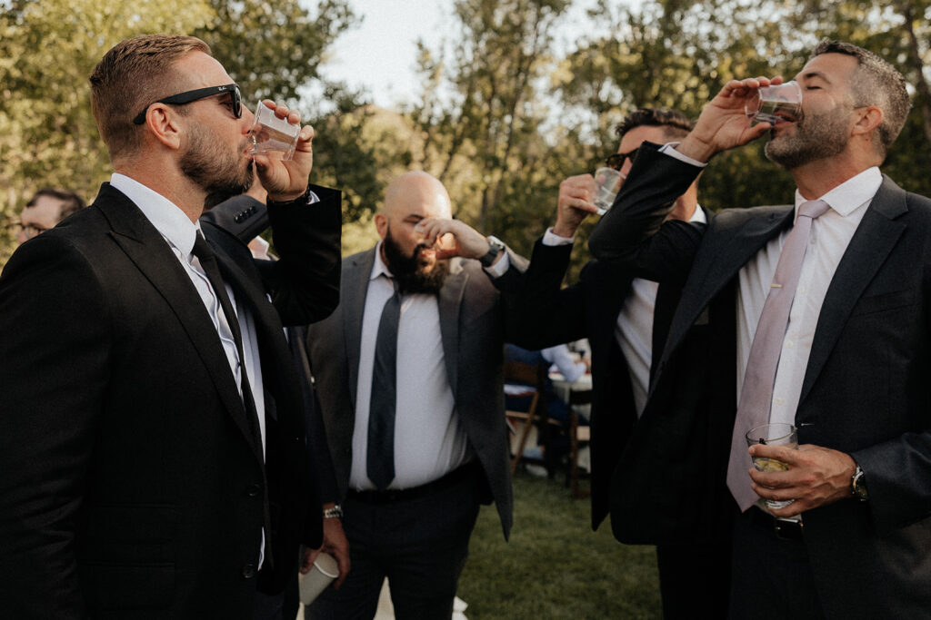 groom and his friends taking a shot