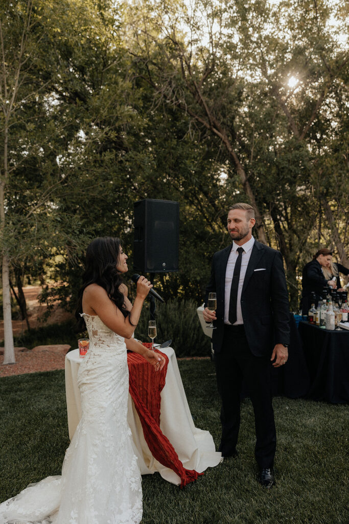 bride and groom giving a speech at their wedding 