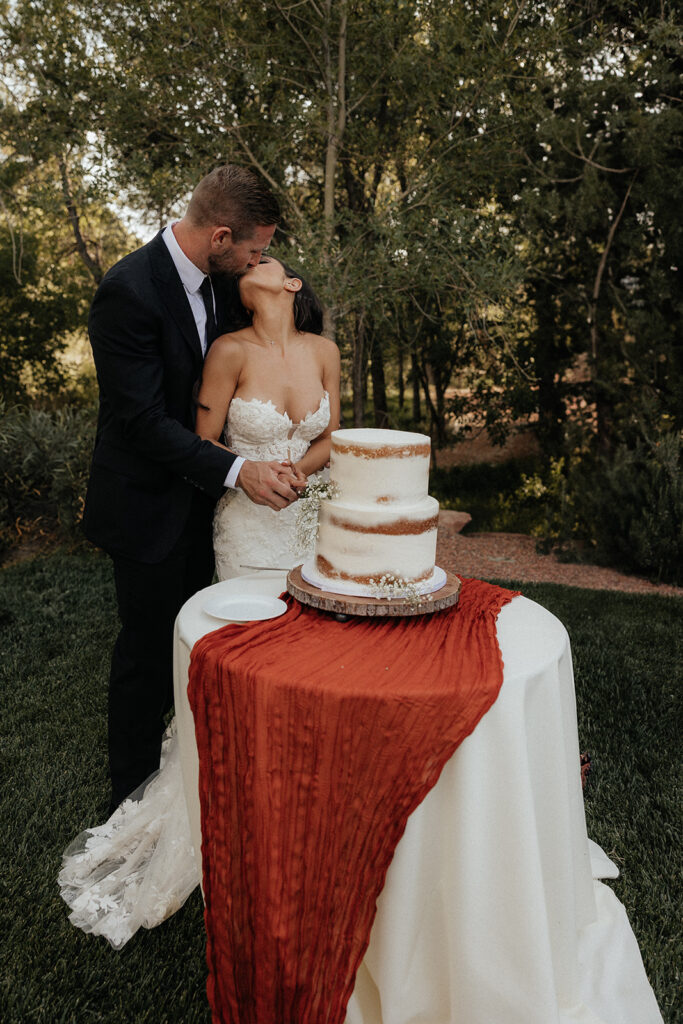 bride and groom trying their wedding cake 