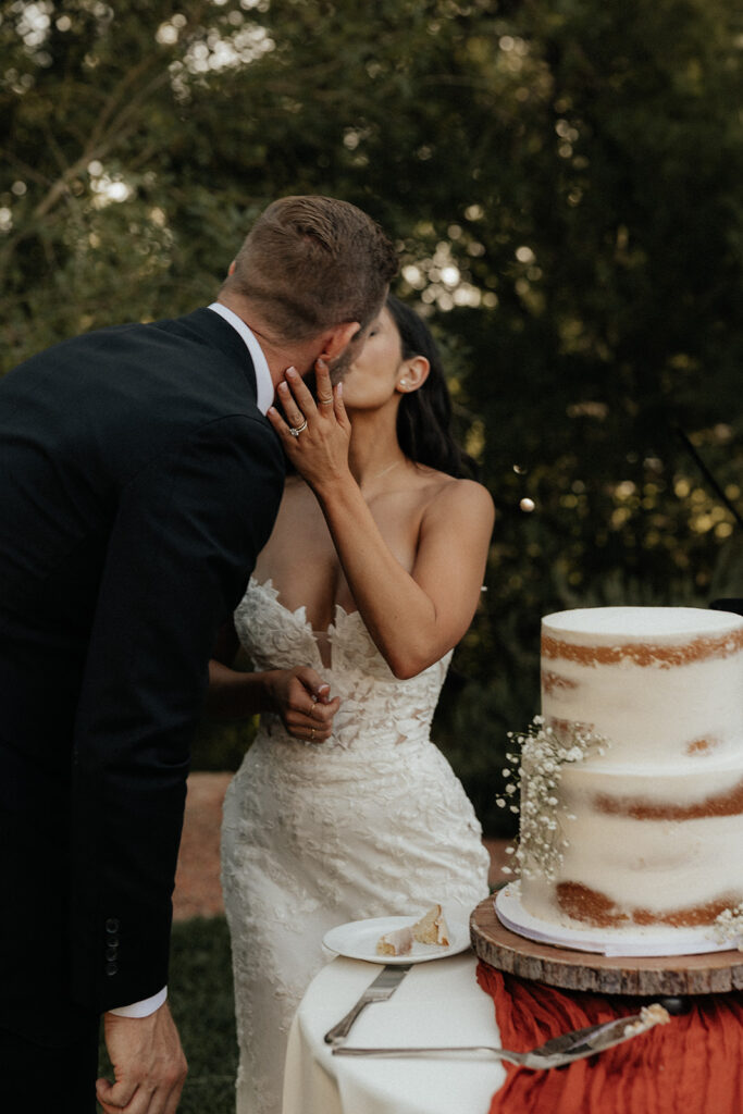 bride and groom kissing at their elegant and adventurous wedding 