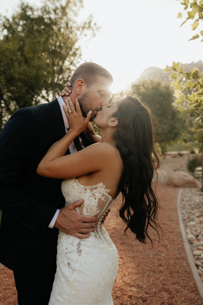 bride and groom kissing after their wedding reception