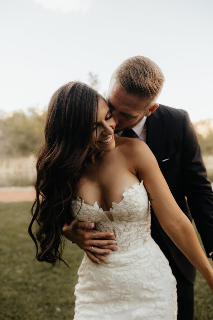 bride and groom hugging 