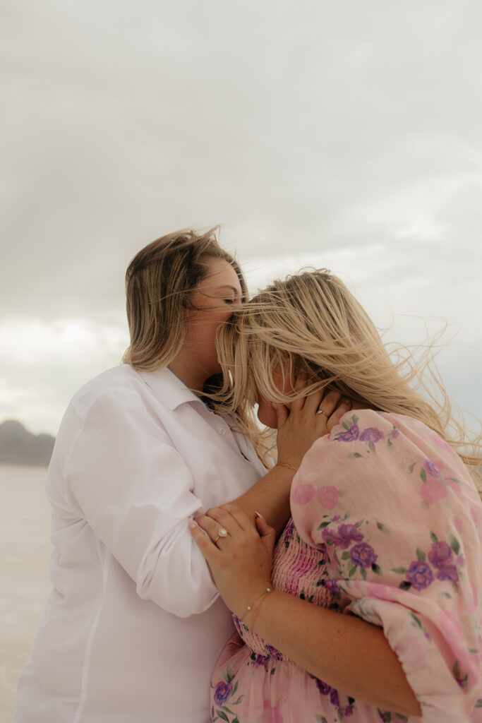 happy couple kissing during their playful elopement photoshoot