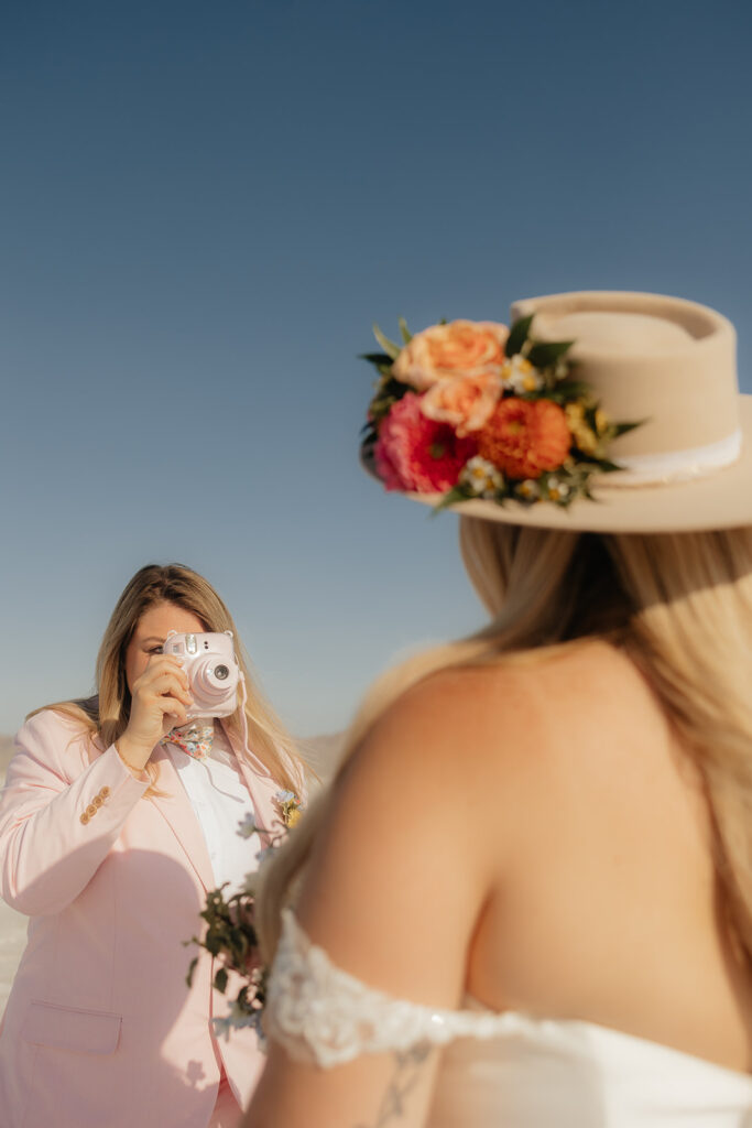 couple taking polaroid pictures of each other 