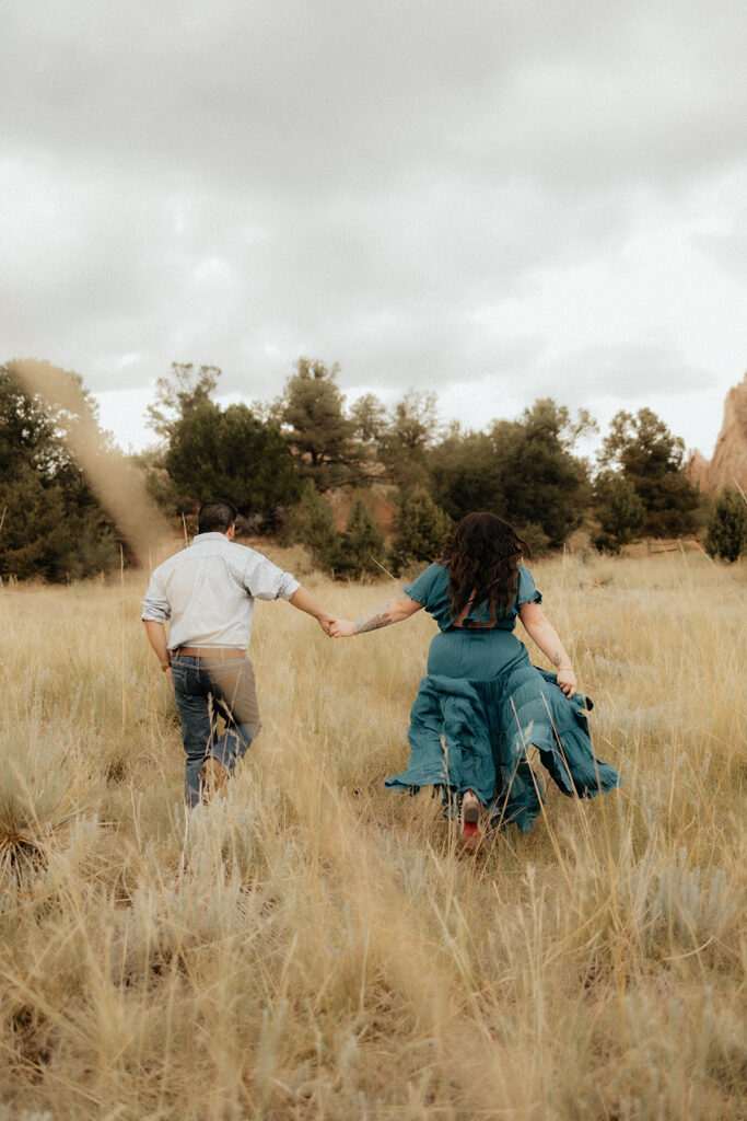 couple walking around garden of the gods during their photoshoot