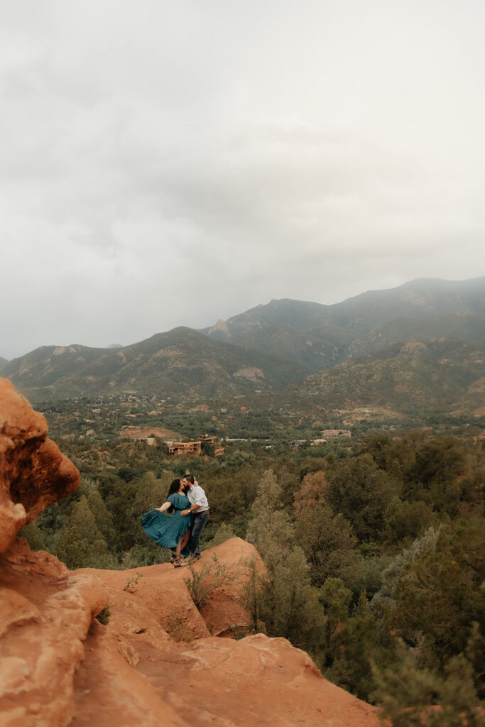 newly engaged couple kissing