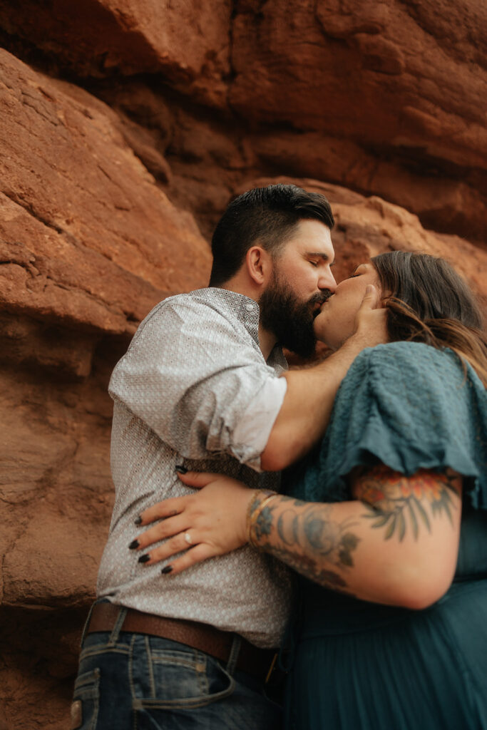 newly engaged couple kissing