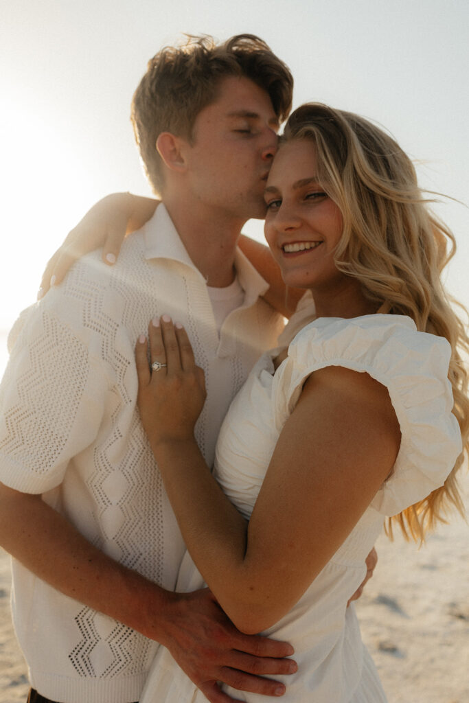 fiance kissing his fiance on the forehead 