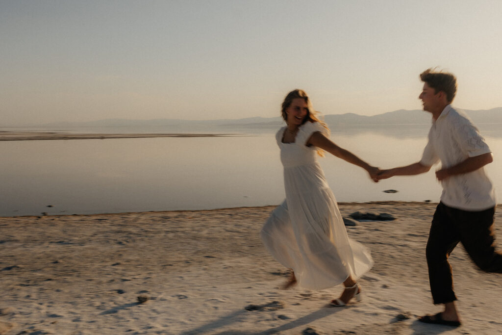 couple running around the beach 