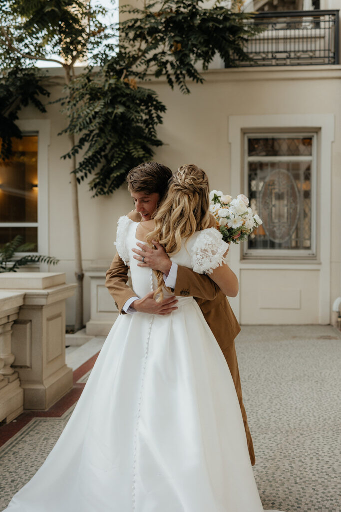 bride and groom hugging after their first look
