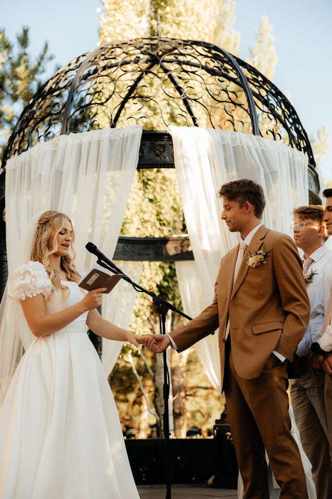 bride and groom reading their vows