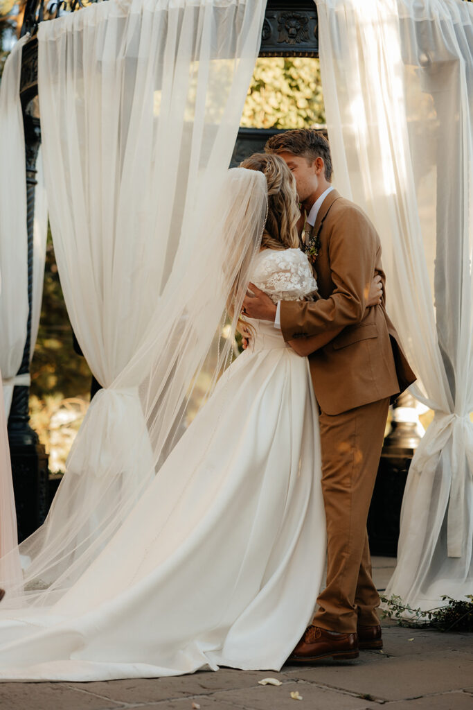 bride and groom kissing after their ceremony