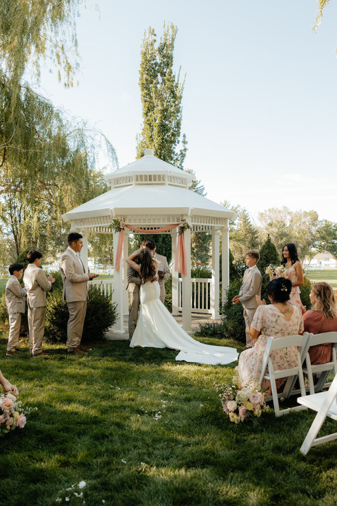 bride and groom kissing after their ceremony