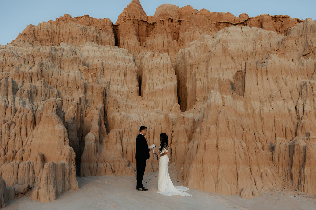 newlyweds reading their vows to each ohter