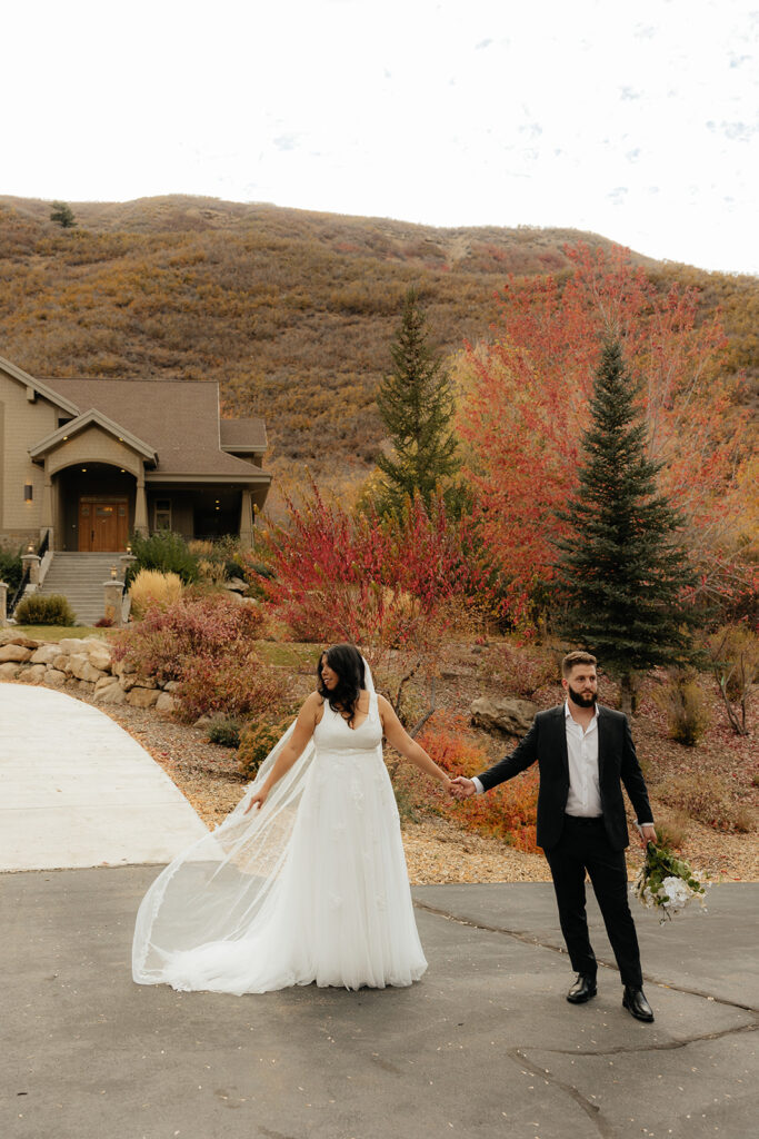 cute picture of the bride and groom holding hands during their bridal portraits