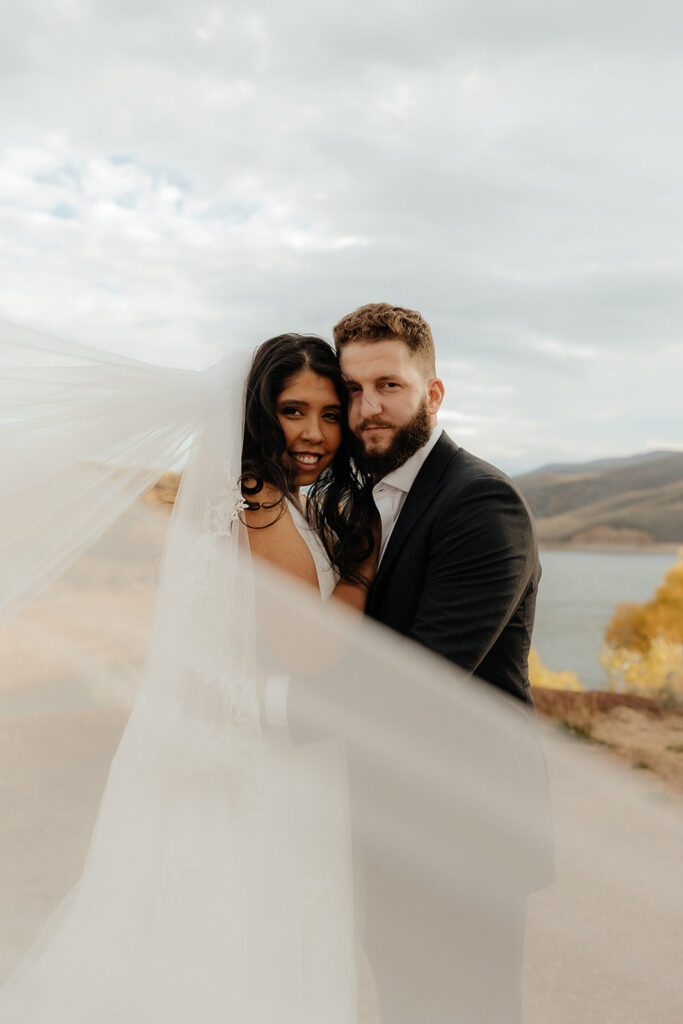 couple smiling at the camera during their bridal session