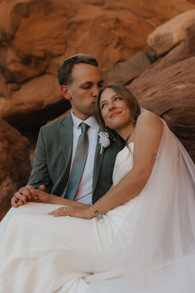 groom kissing the bride on the forehead