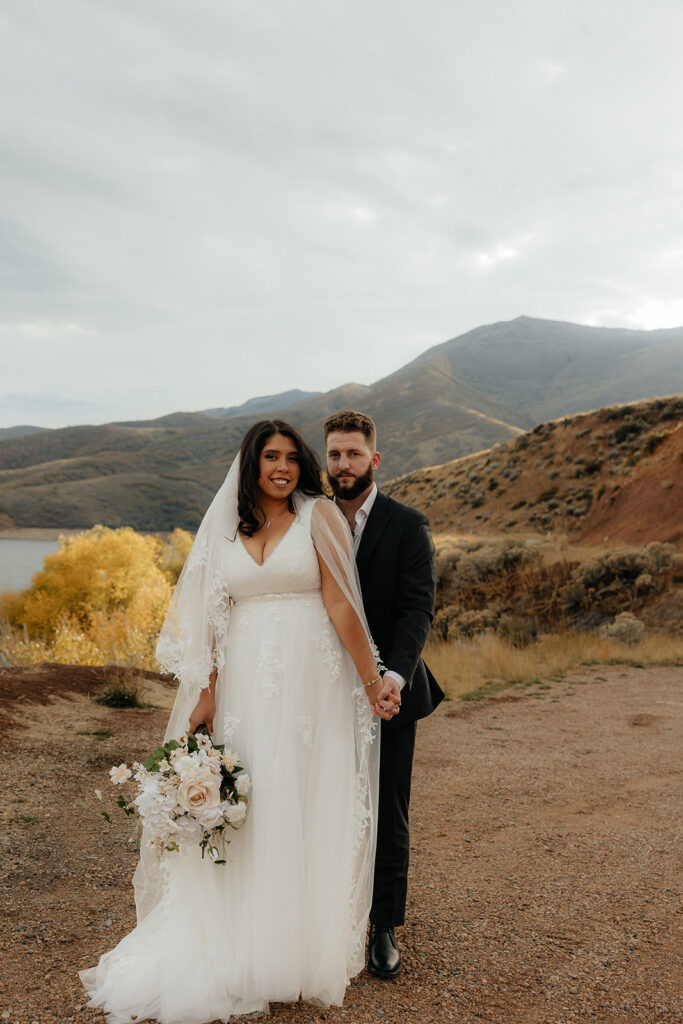 picture of the bride and groom smiling at the camera during their photoshoot