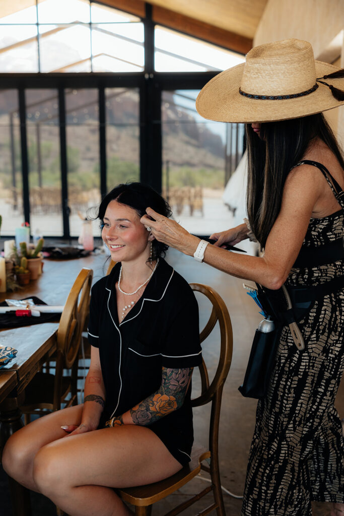 bride getting her makeup done for the ceremony