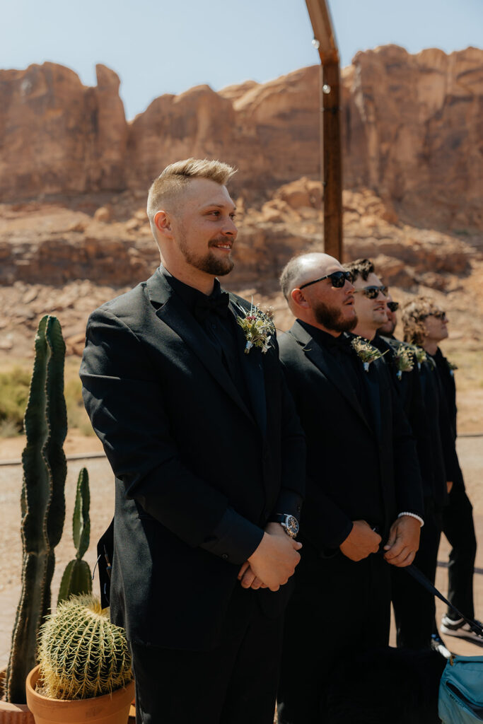 groom watching the bride walk down the aisle