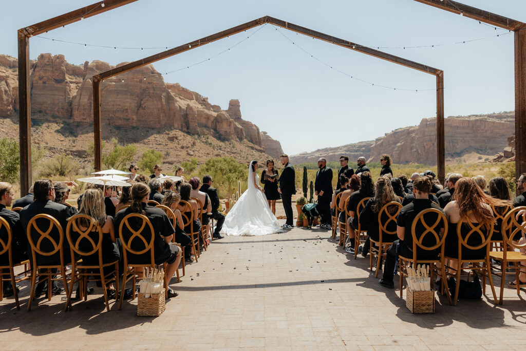 stunning picture of the bride and groom holding hands during their ceremony