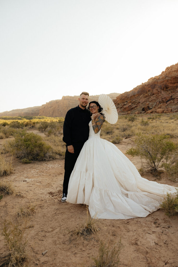 Picture of the newlyweds smiling at the camera