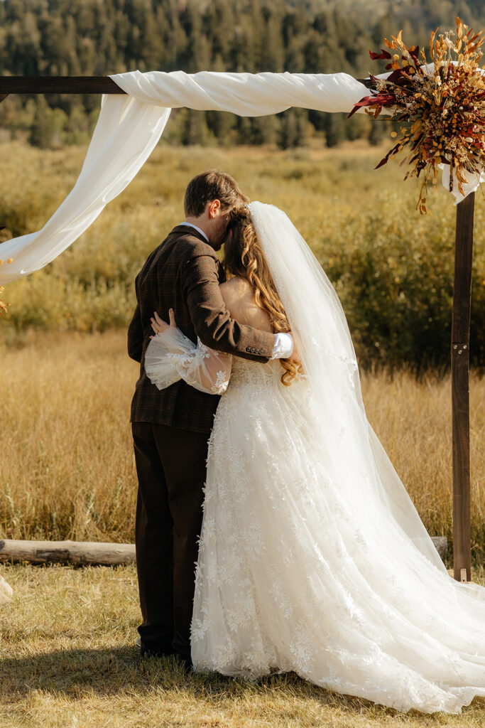 bride and groom hugging during their ceremony