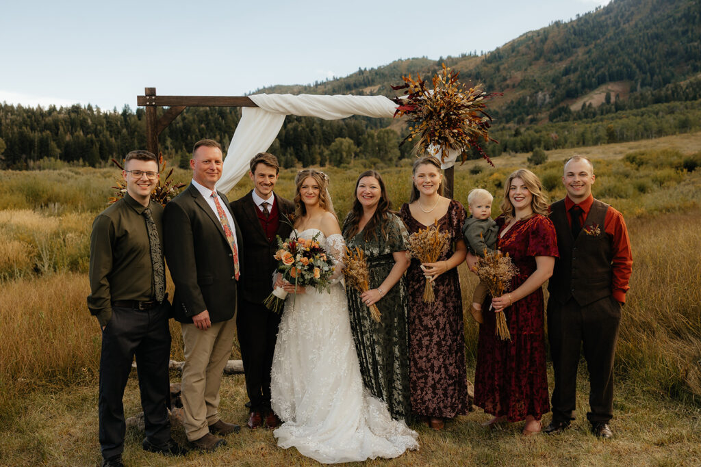 cute picture of the bride and groom with their family