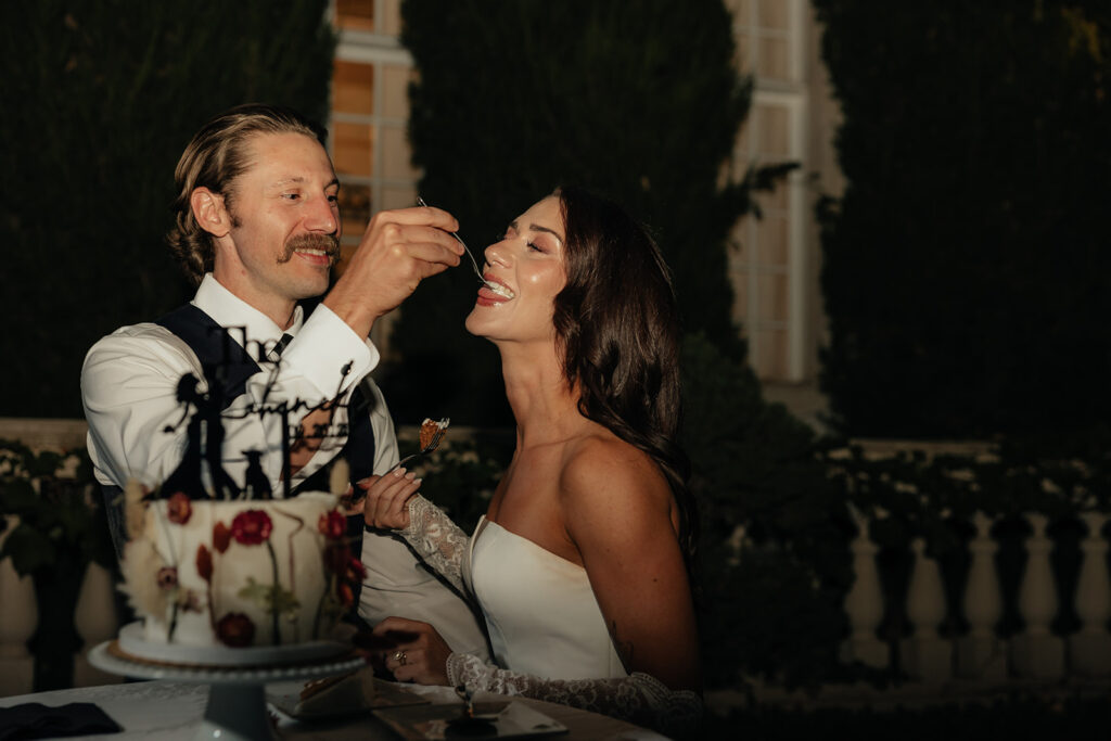 cute picture of the newlyweds trying their wedding cake