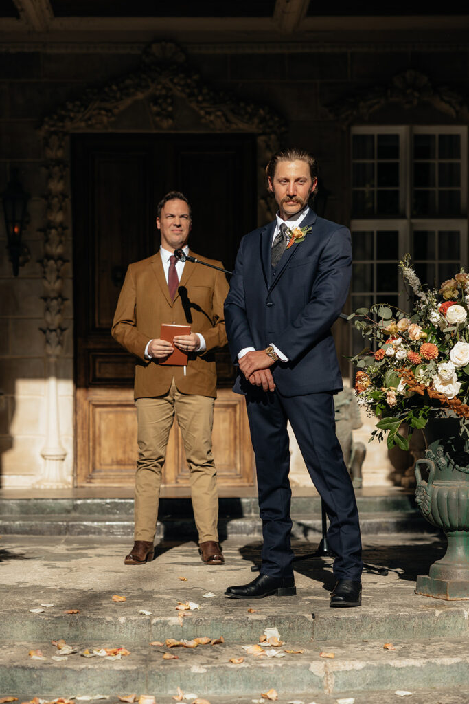 portrait of the groom watching the bride walk down the aisle