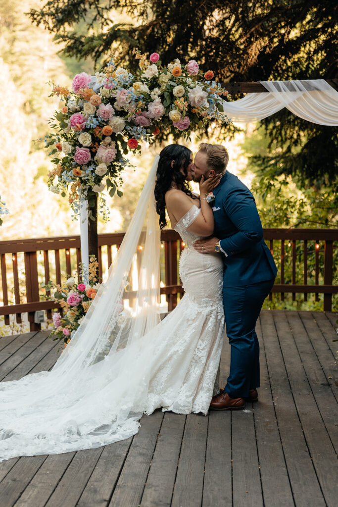 beautiful picture of the newlyweds kissing after their ceremony