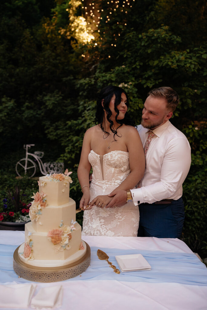 cute picture of the newlyweds cutting their wedding cake