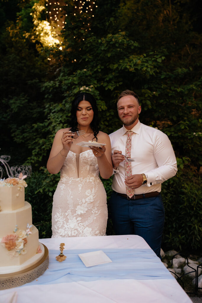 beautiful picture of the newlyweds trying their wedding cake