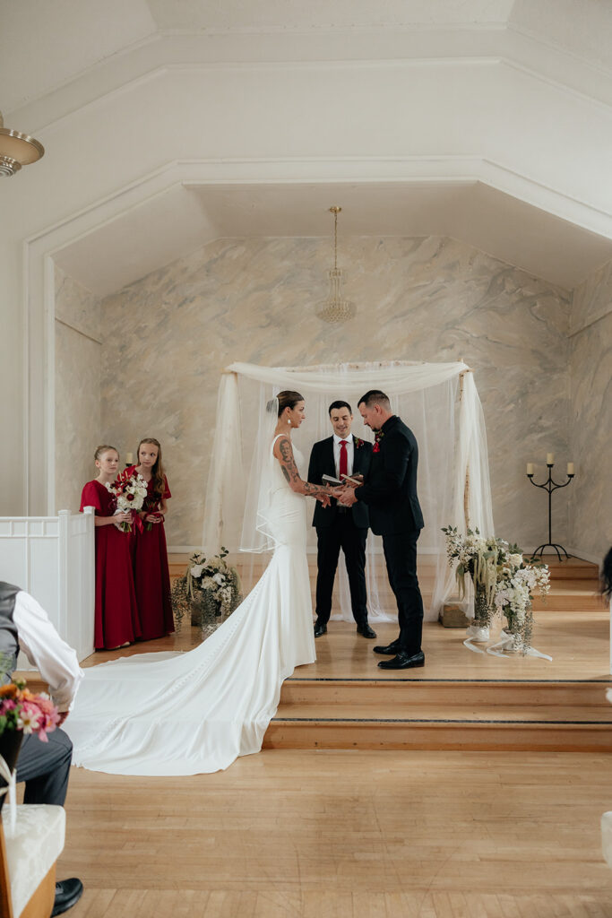 bride and groom holding hands during their ceremony