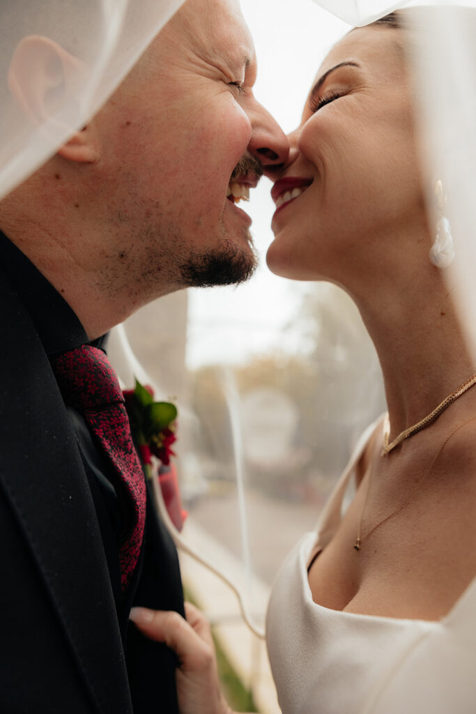 portrait of the newlyweds smiling at each other