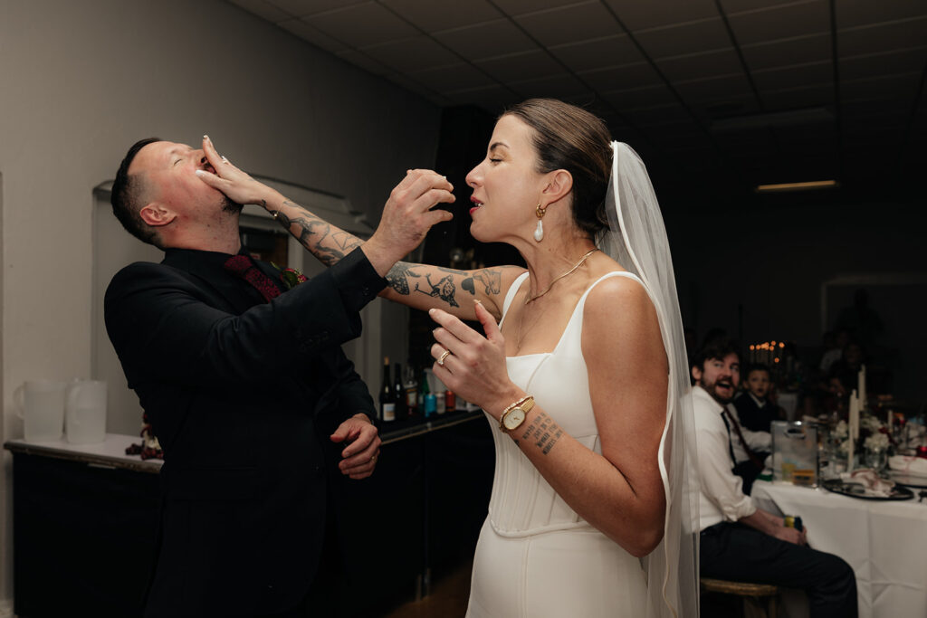 picture of the newlyweds trying their wedding cake