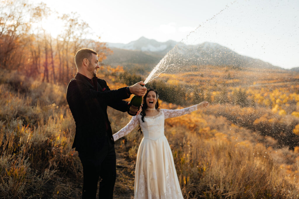 couple celebrating their elopement with champagne